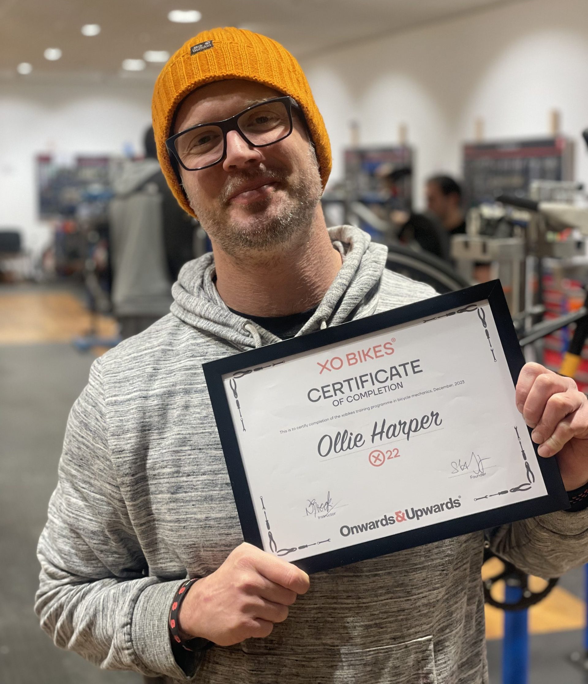 Ollie receiving his XO Bikes training course certificate.
